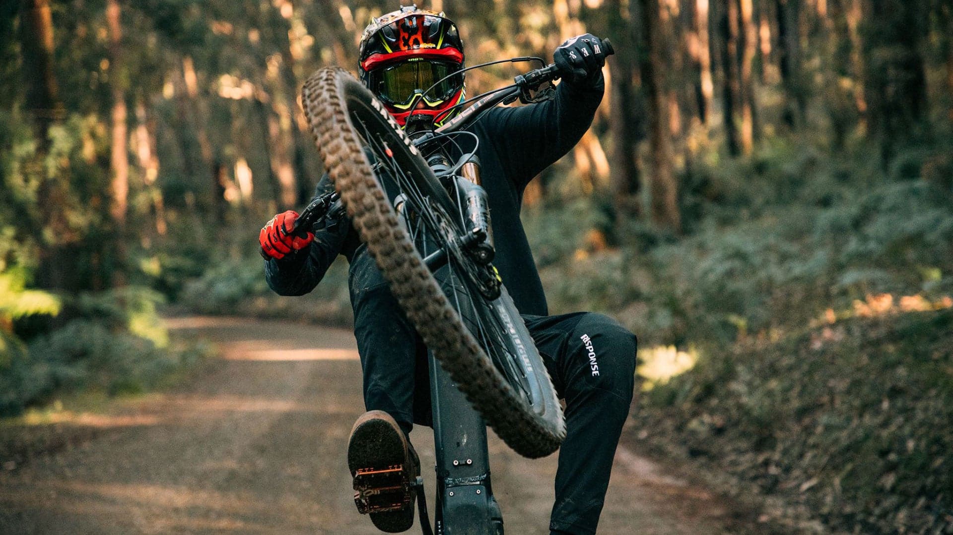 Rider on a Patrol mountain bike on a forest trail
