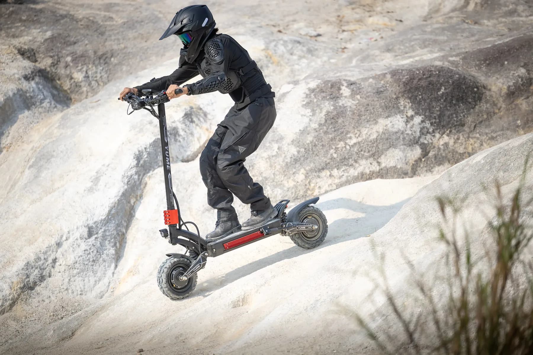 YUME Raptor 2 electric scooter climbing a bare rock face
